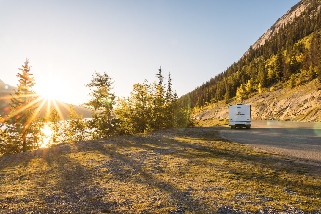 RV traveling on a scenic mountain road at sunset